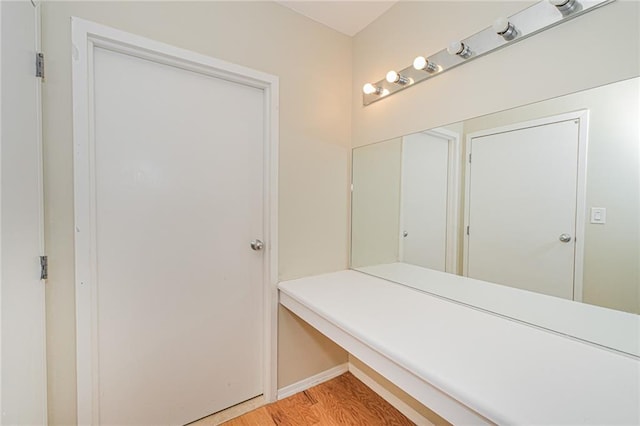 bathroom with wood finished floors and baseboards