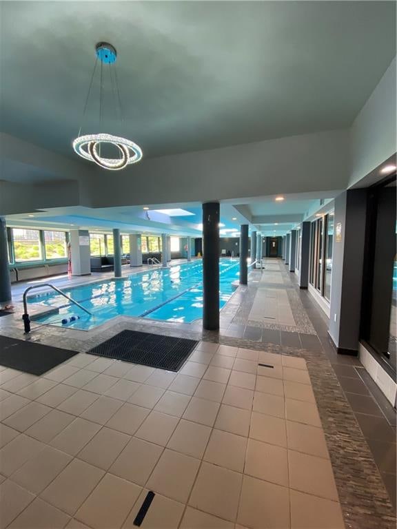 indoor community pool with a chandelier