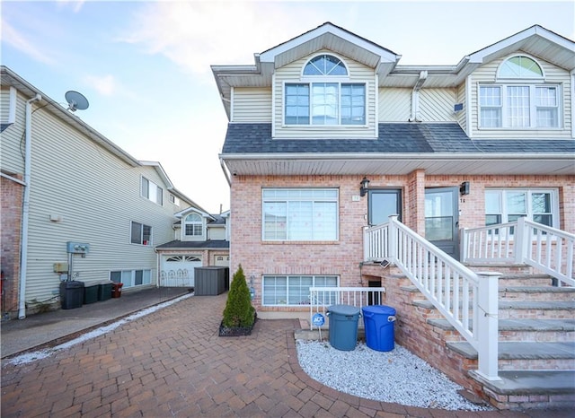 78 Darnell Ln, Staten Island, NY 10309 - townhome / multi-family property with brick siding, driveway, roof with shingles, and a garage