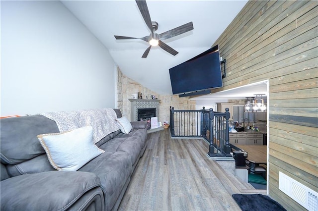 78 Darnell Ln, Staten Island, NY 10309 - living area featuring wooden walls, ceiling fan, a fireplace, wood finished floors, and vaulted ceiling