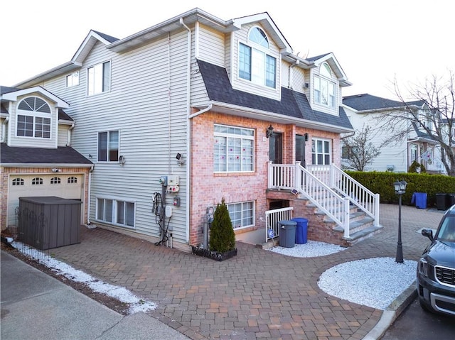 78 Darnell Ln, Staten Island, NY 10309 - view of front facade with roof with shingles, an attached garage, decorative driveway, and brick siding