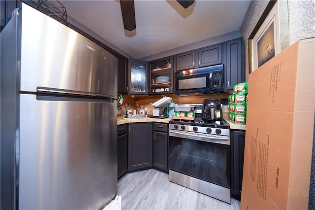 78 Darnell Ln, Staten Island, NY 10309 - kitchen with light wood-style floors, a ceiling fan, light countertops, glass insert cabinets, and stainless steel appliances