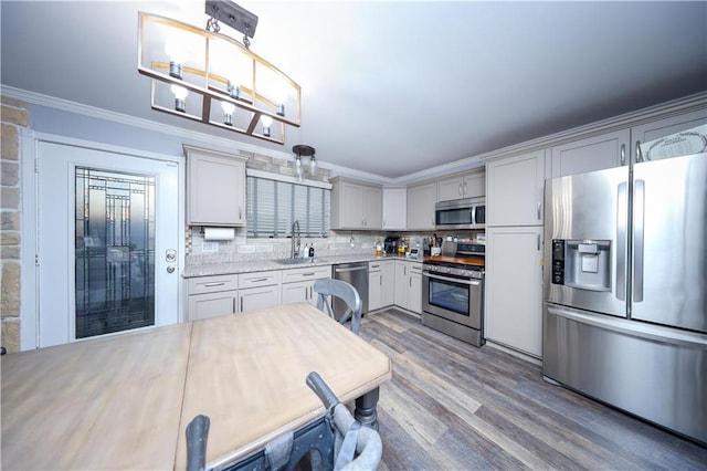 78 Darnell Ln, Staten Island, NY 10309 - kitchen featuring decorative backsplash, wood finished floors, light countertops, ornamental molding, and stainless steel appliances