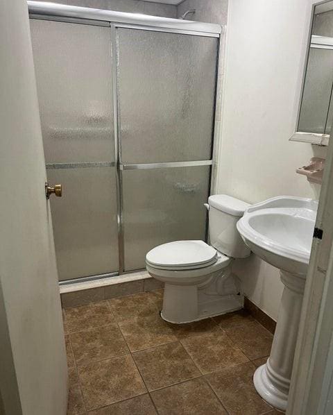 5 Windham Loop Unit 1E, Staten Island, NY 10314 - full bathroom featuring a stall shower and toilet