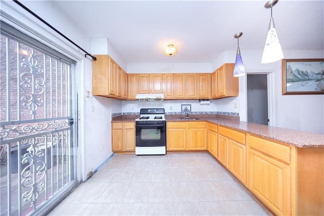 kitchen featuring gas range oven, under cabinet range hood, a sink, light tile patterned flooring, and stone counters