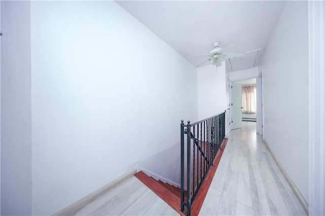 hall featuring an upstairs landing, wood finished floors, and attic access