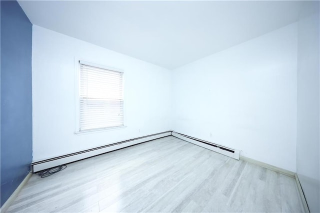 spare room featuring wood finished floors and baseboards