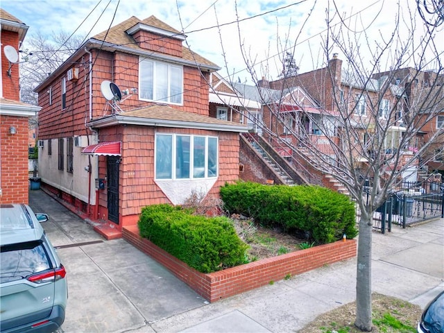 view of side of property featuring roof with shingles