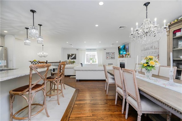 dining room featuring recessed lighting, a chandelier, wood finished floors, and visible vents
