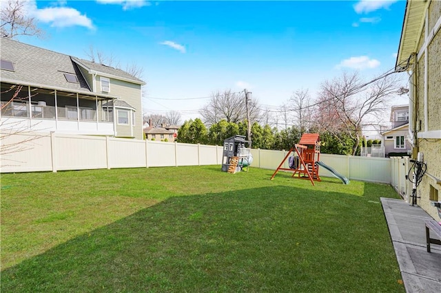 view of yard featuring a fenced backyard and a playground