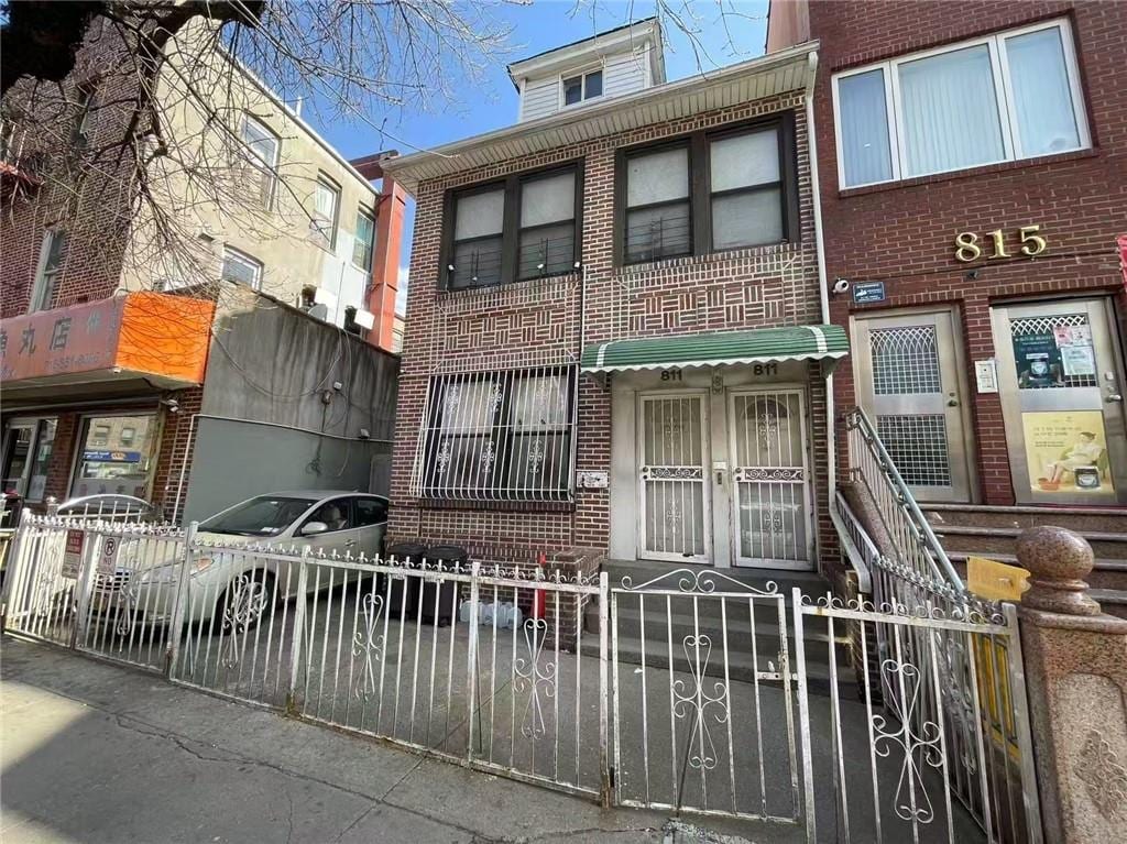 811 59th St, Brooklyn, NY 11220 - view of front of property with a fenced front yard and brick siding
