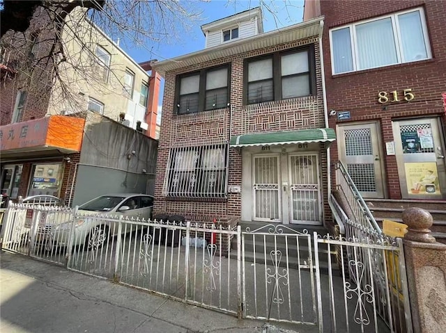 811 59th St, Brooklyn, NY 11220 - view of front of property with a fenced front yard and brick siding