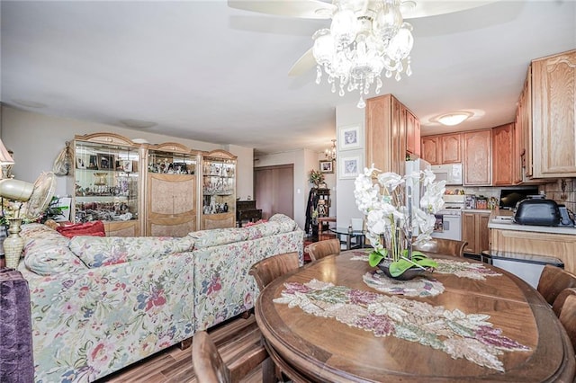 dining space featuring a ceiling fan and wood finished floors