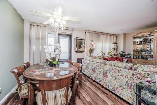 dining area with wood finished floors, ceiling fan, and baseboards