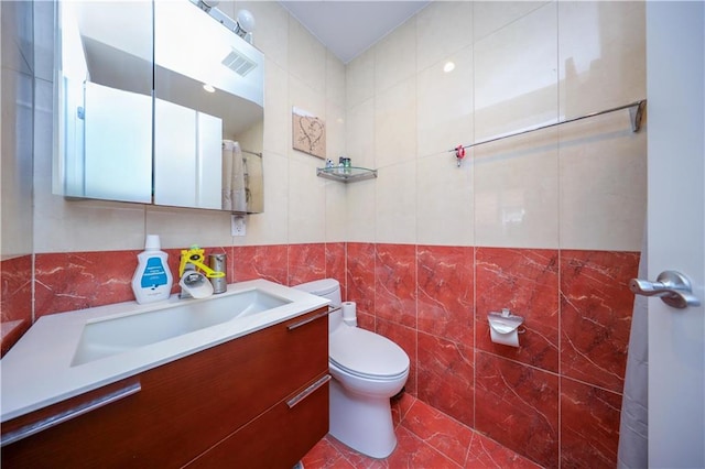 2679 E 24th St Unit 1B, Brooklyn, NY 11235 - bathroom with tile walls, marble look tiles, toilet, and vanity