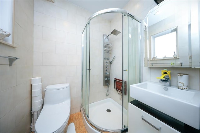 2679 E 24th St Unit 1B, Brooklyn, NY 11235 - bathroom featuring toilet, a stall shower, vanity, and tile walls
