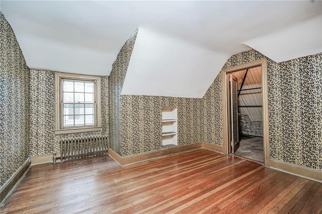 8044 Narrows Ave, Brooklyn, NY 11209 - additional living space featuring radiator heating unit, wallpapered walls, hardwood / wood-style floors, and vaulted ceiling