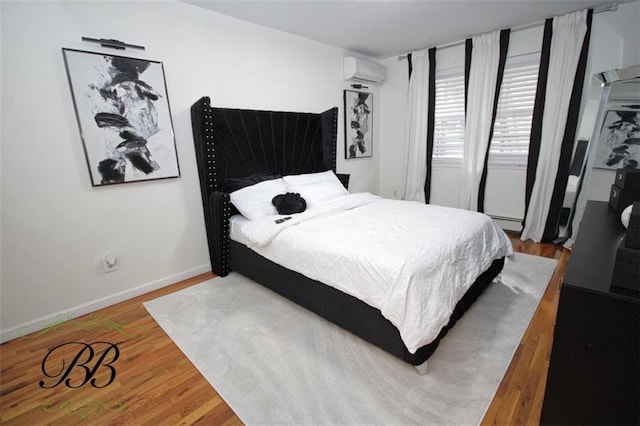 2070 Pearson St, Brooklyn, NY 11234 - bedroom with a wall unit AC, wood finished floors, and baseboards