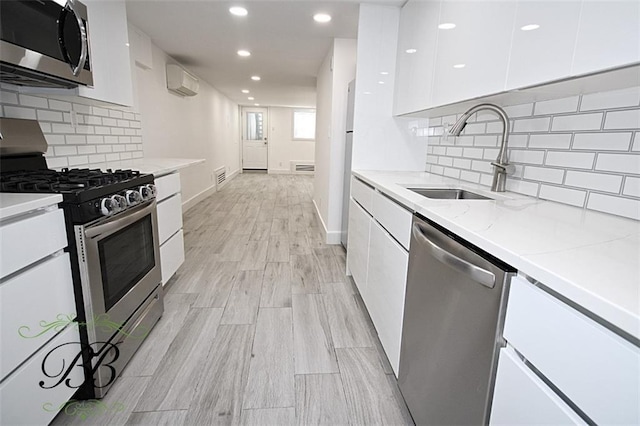 2070 Pearson St, Brooklyn, NY 11234 - kitchen featuring appliances with stainless steel finishes, modern cabinets, white cabinetry, a sink, and recessed lighting