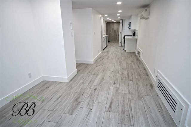 2070 Pearson St, Brooklyn, NY 11234 - hall with recessed lighting, light wood-style flooring, baseboards, and a wall unit AC