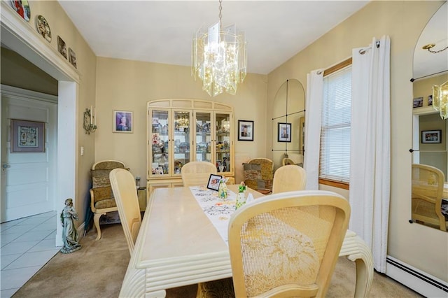 dining room featuring a baseboard heating unit, a chandelier, and light colored carpet