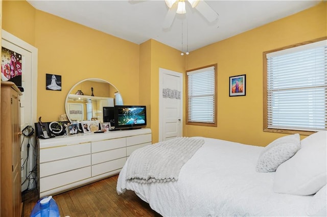 bedroom with dark wood-type flooring and ceiling fan