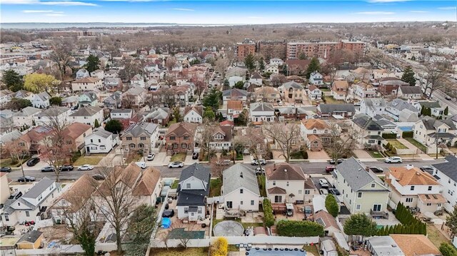 aerial view of property and surrounding area featuring nearby suburban area