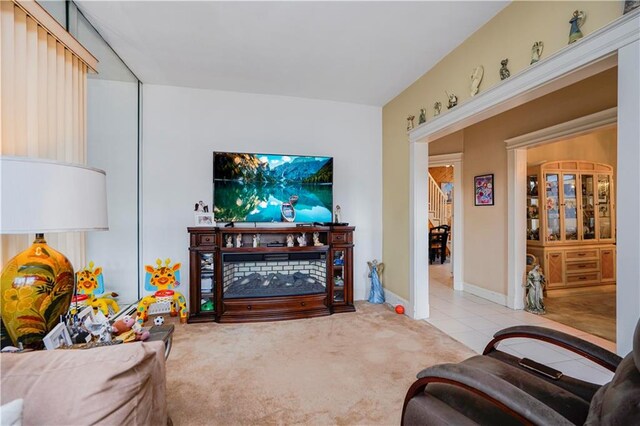 carpeted living area featuring tile patterned flooring