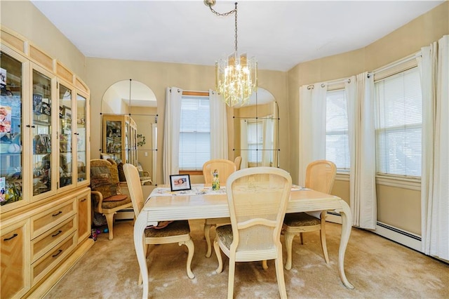 dining room with plenty of natural light, a chandelier, and light carpet