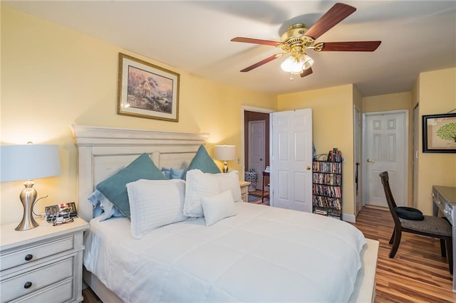bedroom featuring baseboards, ceiling fan, and wood finished floors