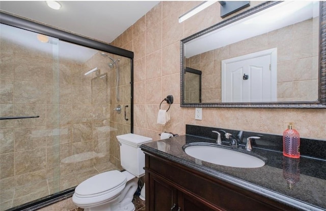 2841 Ford St Unit 1R, Brooklyn, NY 11235 - bathroom with tile walls, a stall shower, vanity, toilet, and backsplash