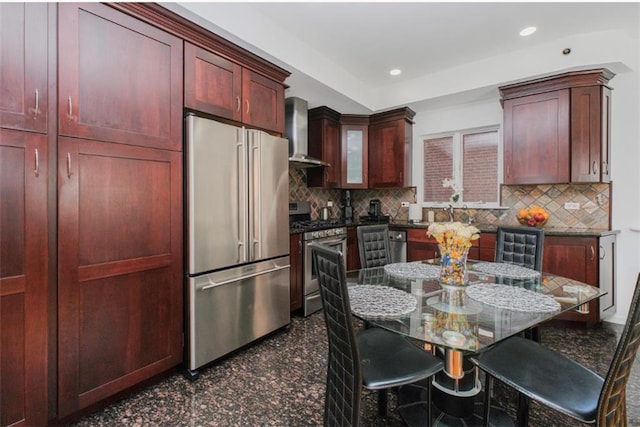 2841 Ford St Unit 1R, Brooklyn, NY 11235 - kitchen featuring stainless steel appliances, wall chimney exhaust hood, tasteful backsplash, a breakfast bar, and recessed lighting