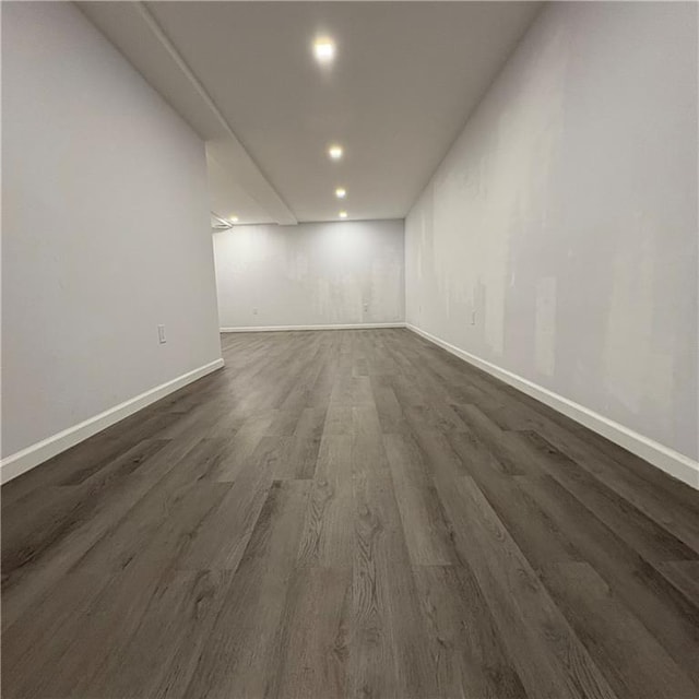 unfurnished room featuring baseboards, recessed lighting, and dark wood-type flooring