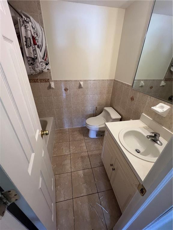 1391 Stanley Ave, East New York, NY 11208 - full bathroom with tile walls, a tub, tile patterned floors, vanity, and toilet