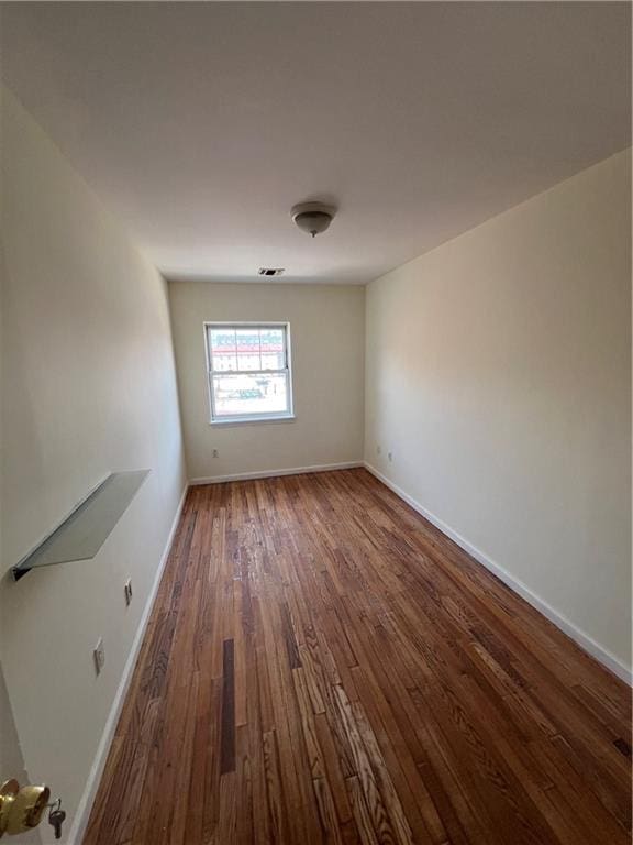 1391 Stanley Ave, East New York, NY 11208 - spare room featuring wood finished floors and baseboards