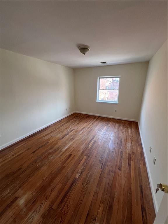 1391 Stanley Ave, East New York, NY 11208 - spare room with dark wood finished floors and baseboards
