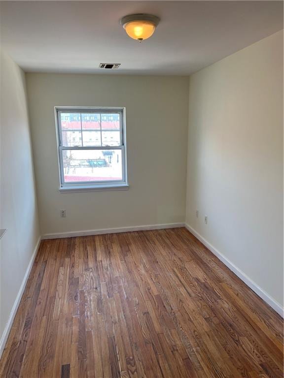 1391 Stanley Ave, East New York, NY 11208 - unfurnished room with wood finished floors and baseboards