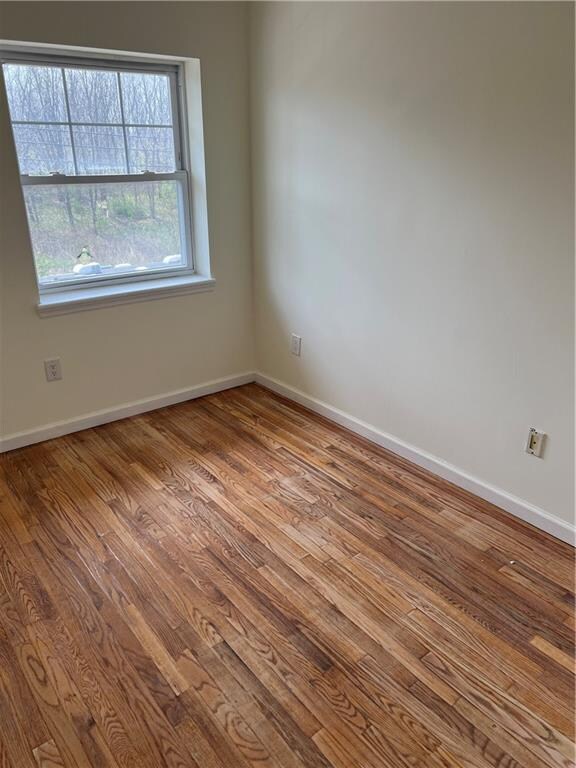 1391 Stanley Ave, East New York, NY 11208 - unfurnished room featuring wood finished floors and baseboards