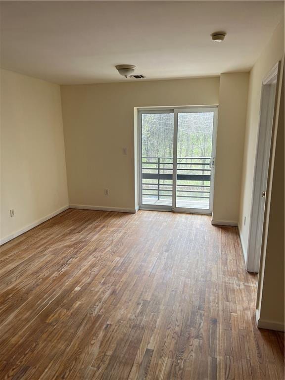 1391 Stanley Ave, East New York, NY 11208 - unfurnished room with wood finished floors, baseboards, and a smoke detector