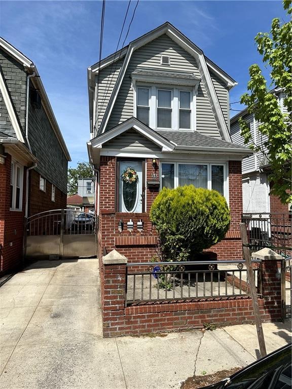 956 E 48th St, Brooklyn, NY 11203 - dutch colonial featuring brick siding, a gambrel roof, and a gate