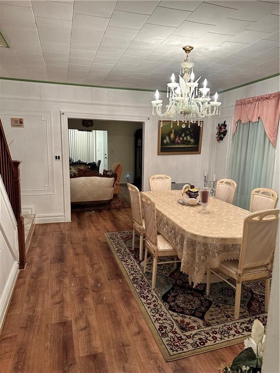 956 E 48th St, Brooklyn, NY 11203 - dining space featuring a chandelier, wood finished floors, and stairs