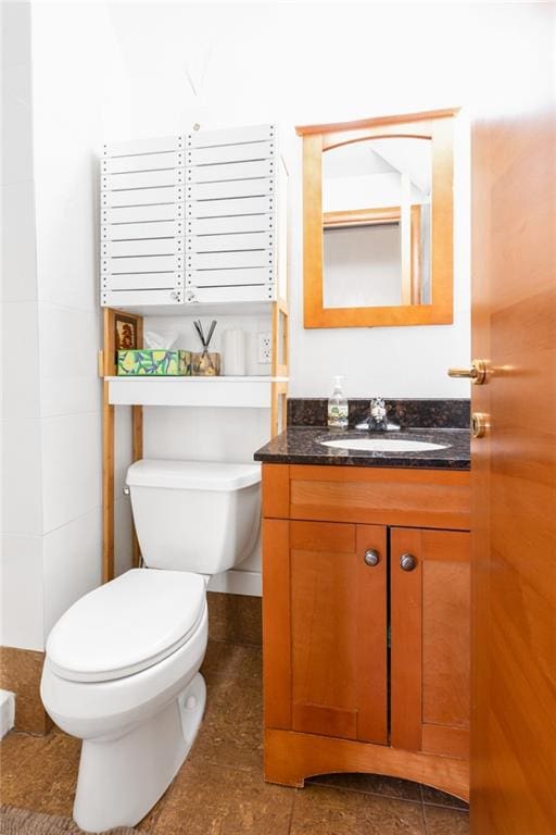 bathroom featuring toilet and vanity