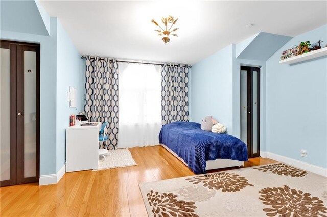 bedroom featuring baseboards and wood finished floors