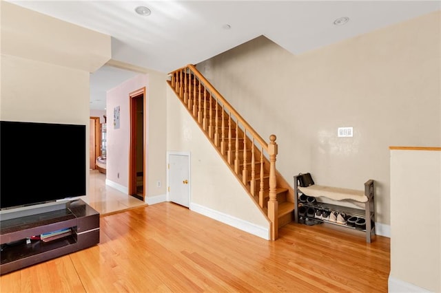 stairs with baseboards and wood finished floors