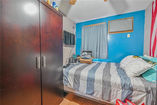 bedroom featuring wood finished floors and a closet