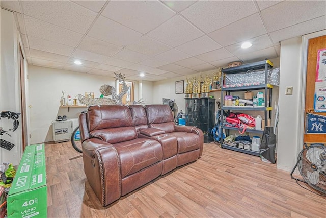 living room with a drop ceiling and wood finished floors