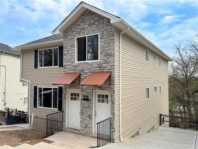 view of front of home featuring a wooden deck and stone siding