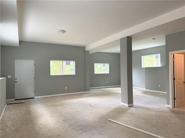 interior space featuring baseboards and a healthy amount of sunlight
