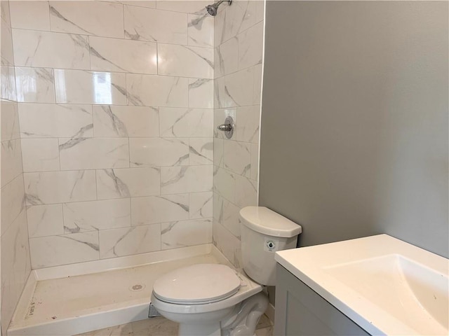 full bathroom with vanity, a shower stall, and toilet