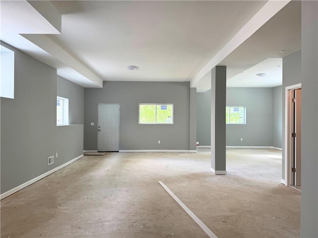 basement with baseboards and a healthy amount of sunlight